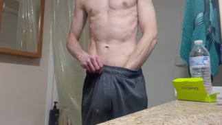 Horny fit guy plays with huge dick in bathroom big solo cumshot